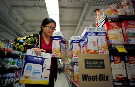 Chinese "daigou" shopping agent Na Wang selects an Australian breakfast cereal product popular in China, during a shopping trip for Chinese customers at an Australian supermarket in Sydney, Australia August 2, 2016. Picture taken August 2, 2016. REUTERS/Jason Reed