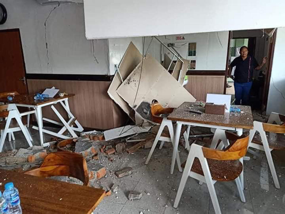 A woman inspects the damage following an earthquake in Ambon, Maluku province, Indonesia, Thursday, Sept. 26, 2019. The strong earthquake Thursday killed a number of people and damaged a bridge, hospital and other buildings on one of Indonesia's less populated islands. (AP Photo)