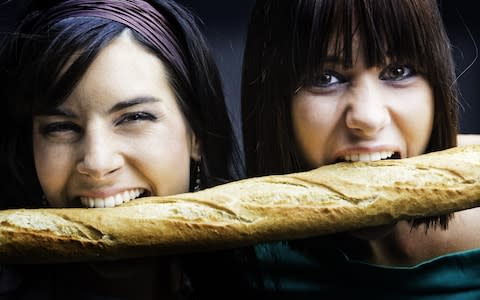 Girls eating a French loaf of bread - Credit: Angel Herrero de Frutos/Getty Images