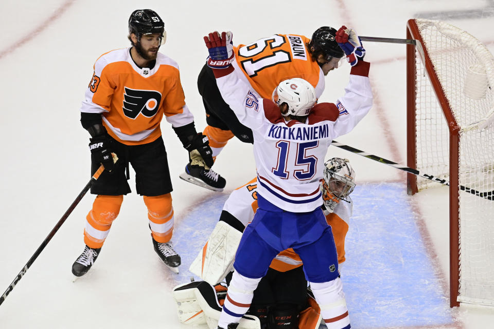 Montreal Canadiens centre Jesperi Kotkaniemi (15) celebrates his goal on Philadelphia Flyers goaltender Carter Hart (79) who lost his stick on the play during first period of NHL Eastern Conference Stanley Cup first round playoff action in Toronto on Friday, Aug. 14, 2020. (Frank Gunn/The Canadian Press via AP)