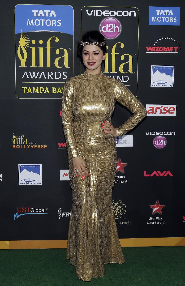 Indian film star Kainaat Arora poses for photographers as she walks the green carpet for the 15th annual International Indian Film Awards Saturday, April 26, 2014, in Tampa, Fla. (AP Photo/Chris O'Meara)