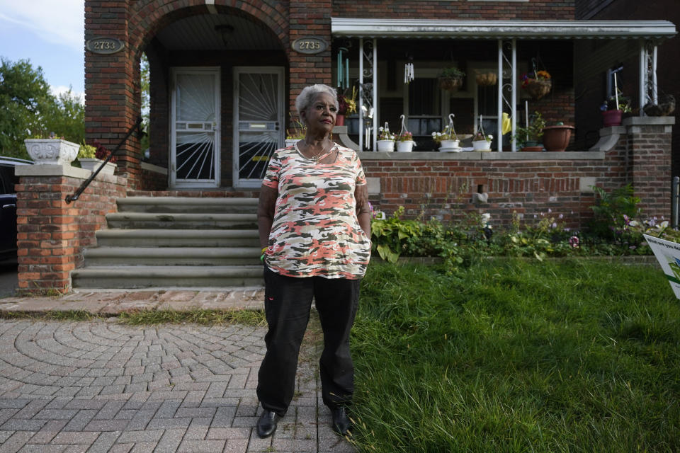 Pamela Jackson-Walters stands outside her home in Detroit, Wednesday, Sept. 21, 2022. Jackson-Walters uses her home internet connection to attend church services virtually and to pursue a graduate degree, but the service AT&T offers in her mostly Black neighborhood is much slower than in other parts of the city. She said she also experienced an internet outage for four weeks during the summer. (AP Photo/Paul Sancya)