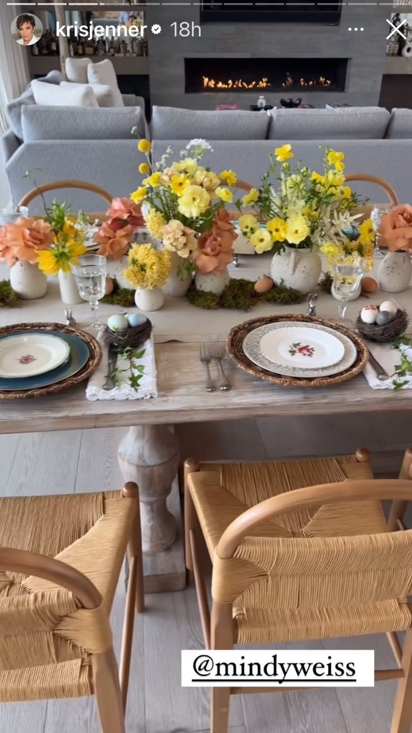 a table with plates and flowers on it