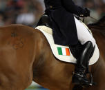 Olympic rings and an Irish Shamrock are displayed on the hindquarters of Louise Lyons' mount Watership Down as they perform their Dressage Test at the Equestrian event held at the Hong Kong Olympic Equestrian Venue in Sha Tin during Day 1 of the Beijing 2008 Olympic Games. (Photo by Julian Herbert/Getty Images)