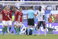 France's Paul Pogba takes on British referee Michael Oliver during the Euro 2020 soccer championship group F match between Hungary and France, at the Ferenc Puskas stadium, in Budapest, Saturday, June 19, 2021. (Alex Pantling, Pool via AP)