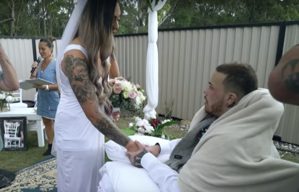 Navar Herbert and Maia Falwasser hold hands during the wedding ceremony. 