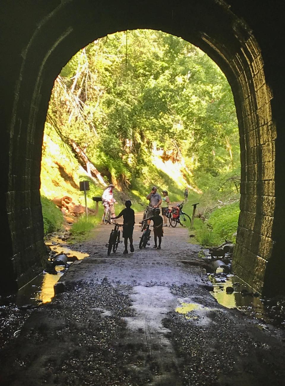 Cyclists prepare to enter a tunnel on the Elroy-Sparta State Trail.