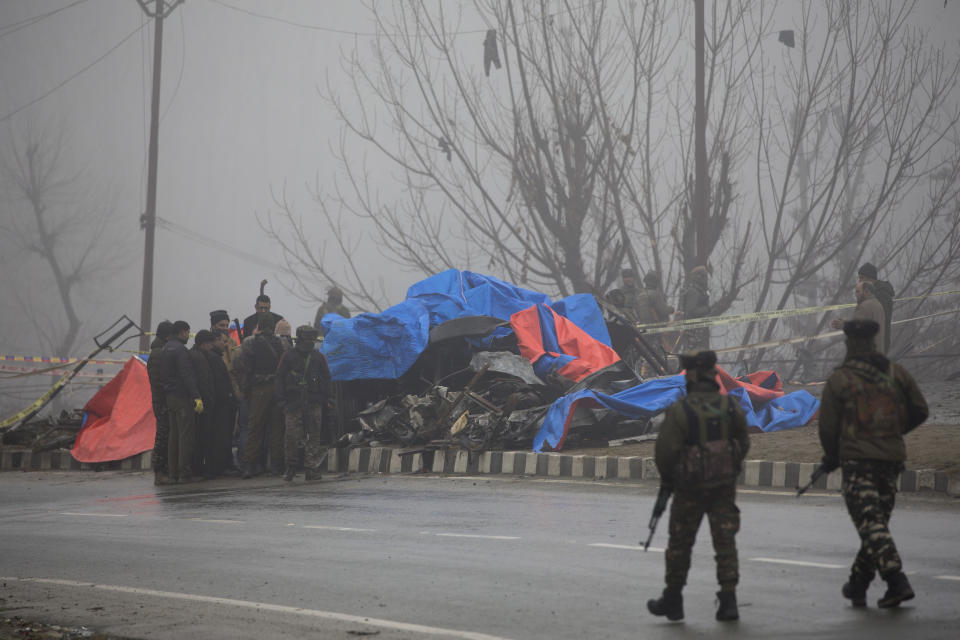 Officials from Forensic Science Laboratory(FSL) inspect the wreckage of a bus at the site of Thursday's explosion in Pampore, Indian-controlled Kashmir, Friday, Feb. 15, 2019. Security officials say the death toll from a car bombing in Indian-controlled Kashmir has climbed to at least 40 after rebels fighting against Indian rule struck a paramilitary convoy in the single deadliest attack in the divided region's volatile history. (AP Photo/Dar Yasin)