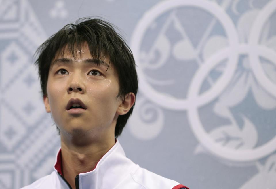 Yuzuru Hanyu of Japan waits for his results after competing in the men's short program figure skating competition at the Iceberg Skating Palace during the 2014 Winter Olympics, Thursday, Feb. 13, 2014, in Sochi, Russia. (AP Photo/Ivan Sekretarev)