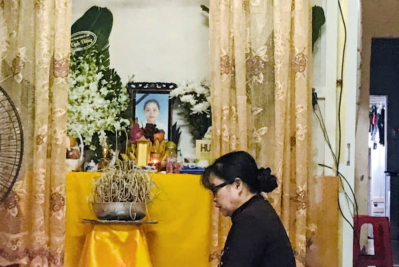 FILE PHOTO: A woman prays at an altar with an image of Pham Thi Tra My, a suspected victim of 39 deaths in a truck container in UK, at her home in Ha Tinh province