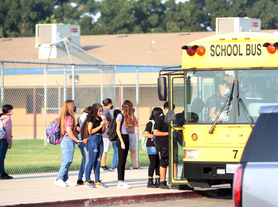 School kids take a bus ride from Pleasant Elementary School on Aug. 12, 2021, the first day of school.