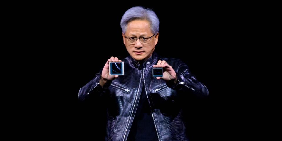 Nvidia CEO Jensen Huang holds two products on a stage.