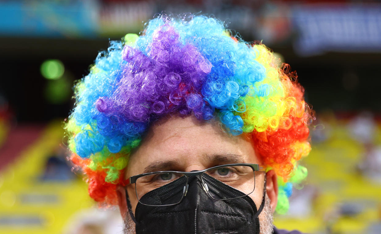 MUNICH, GERMANY - JUNE 23: A fan is seen with a rainbow wig prior to the UEFA Euro 2020 Championship Group F match between Germany and Hungary at Allianz Arena on June 23, 2021 in Munich, Germany. (Photo by Kai Pfaffenbach - Pool/Getty Images)