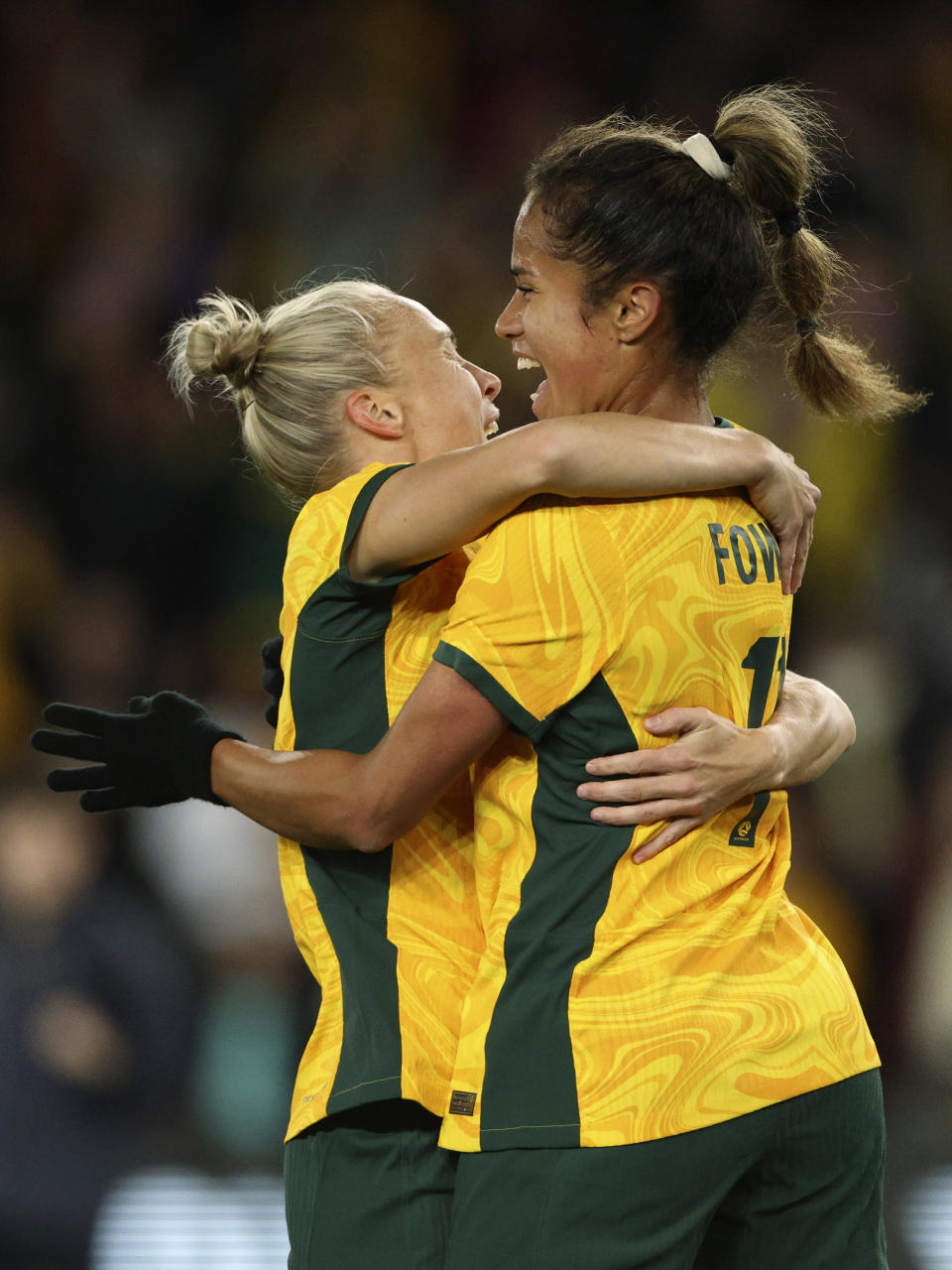 Australia's Mary Fowler, right, is congratulated by teammate Tameka Yallop after scoring against France during their friendly soccer match in Melbourne, Friday, July 14, 2023, ahead of the Women's World Cup. (AP Photo/Hamish Blair)