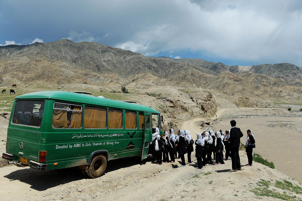 Afghan schoolgirls board a bus in Qara Zaghan village in Baghlan province on May 7, 2013.  