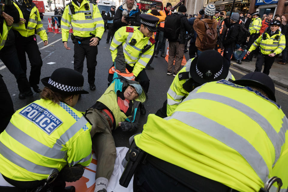 Police officers arrest environmental activists from Just Stop Oil. (Future Publishing via Getty Images)