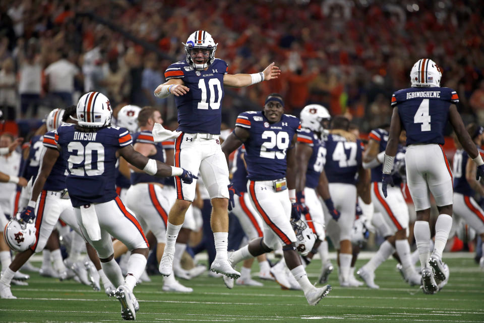 Auburn quarterback Bo Nix (10) celebrates with teammates after Auburn came from behind to defeat Oregon following an NCAA college football game, Saturday, Aug. 31, 2019, in Arlington, Texas. Auburn won 27-21. (AP Photo/Ron Jenkins)