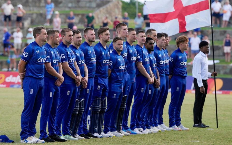 England's captain Jos Buttler, left, and teammates line up