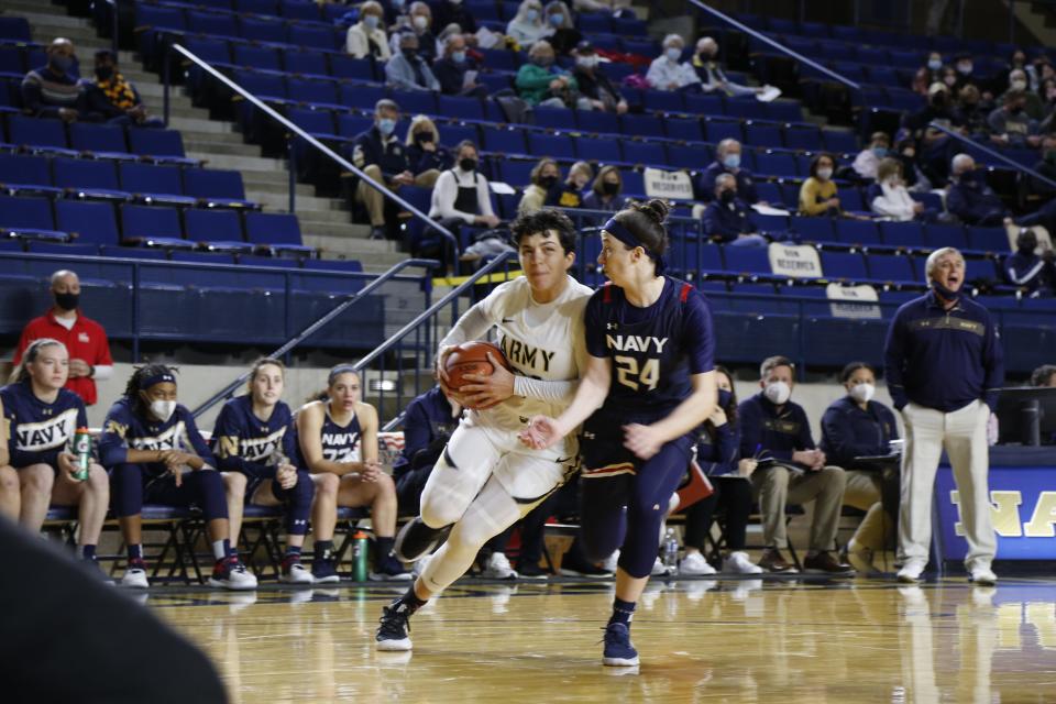 Army's Alissa Fallon, left, drives to the basket against Navy's Lindsay Llewellyn during Saturday's game at Annapolis, Maryland. Navy prevailed 61-60. ARMY ATHLETICS