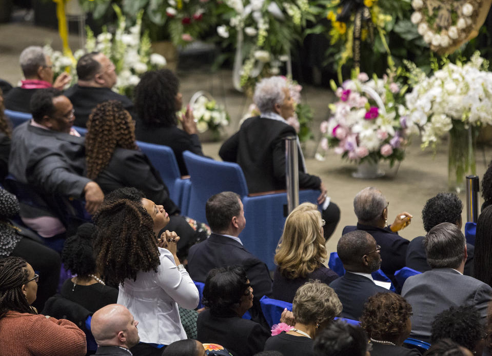 A woman stands during the memorial service for NASA mathematician Katherine Johnson on Saturday, March 7, 2020, at Hampton University Convocation Center in Hampton, Va. Johnson, a mathematician who calculated rocket trajectories and earth orbits for NASA’s early space missions and was later portrayed in the 2016 hit film “Hidden Figures,” about pioneering black female aerospace workers died on Monday, Feb. 24, 2020. She was 101. (Kaitlin McKeown /The Virginian-Pilot via AP)