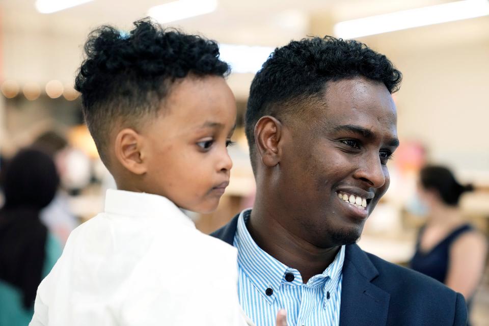 Afkab Hussein smiles while hugging his youngest son, Zain, 2, who arrived from Kenya at the John Glenn Columbus International Airport on Thursday.