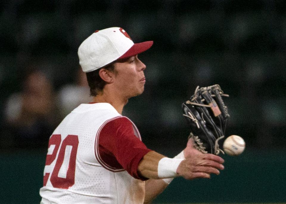 OU's Peyton Graham (20) throws the ball to first base during a 6-4 win against West Virginia on Wednesday night at Globe Life Field in Arlington, Texas.