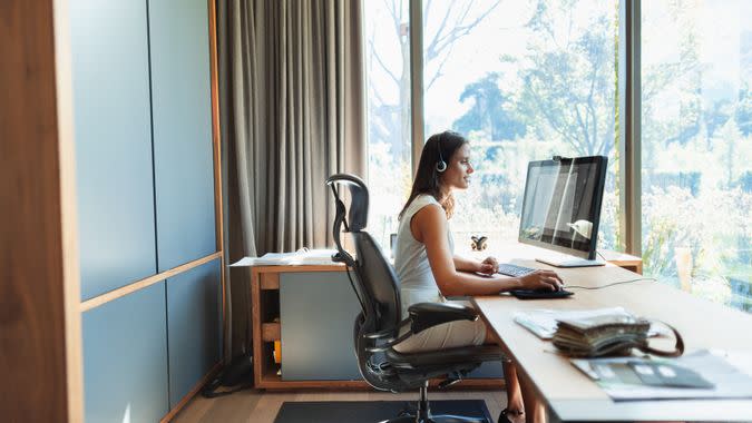 Businesswoman working at computer in home office.