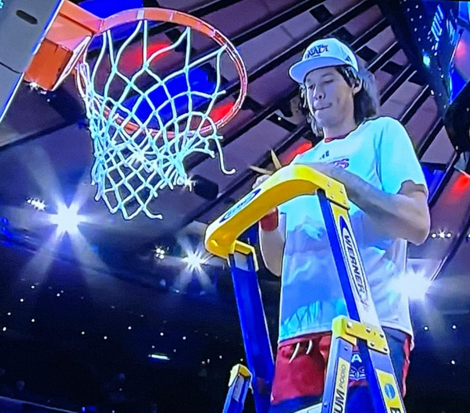Former Charlotte High standout Tre Carroll of Florida Atlantic University cuts down the nets after the Owls defeated Kansas State, 79-76, in the Elite 8.