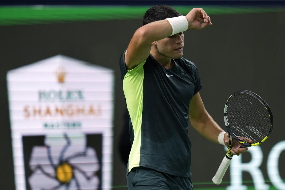 Carlos Alcaraz of Spain wipes his sweat during the 4th round of the men's singles match against Grigor Dimitrov of Bulgaria in the Shanghai Masters tennis tournament at Qizhong Forest Sports City Tennis Center in Shanghai, China, Wednesday, Oct. 11, 2023. (AP Photo/Andy Wong)