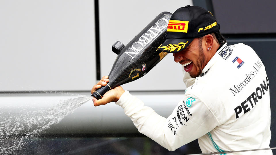 Race winner Lewis Hamilton of Great Britain and Mercedes GP celebrates on the podium during the F1 Grand Prix of Great Britain at Silverstone on July 14, 2019 in Northampton, England. (Photo by Mark Thompson/Getty Images)