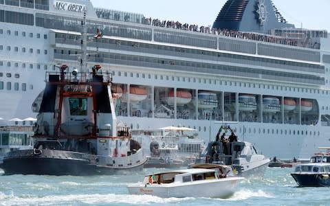 A cruise ship lost control and crashed against a smaller tourist boat at the San Basilio dock in Venice - Credit: REUTERS/Manuel Silvestri