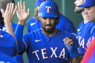 Texas Rangers' Marcus Semien is congratulated after scoring against the Kansas City Royals during the first inning of a baseball game Tuesday, June 28, 2022, in Kansas City, Mo. (AP Photo/Reed Hoffmann)
