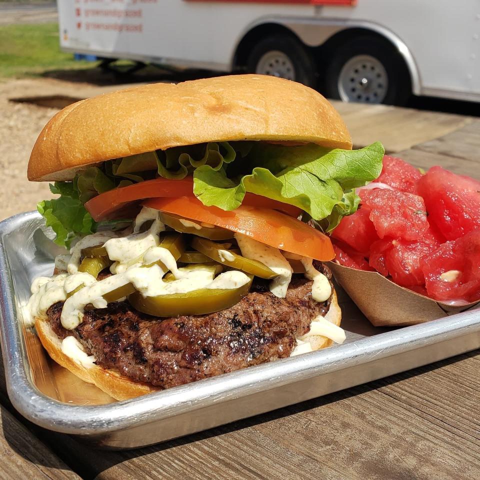 Grown and Grazed offers a Smith Family Farms beef burger. Here it is pictured with a side jalapeno watermelon salad.