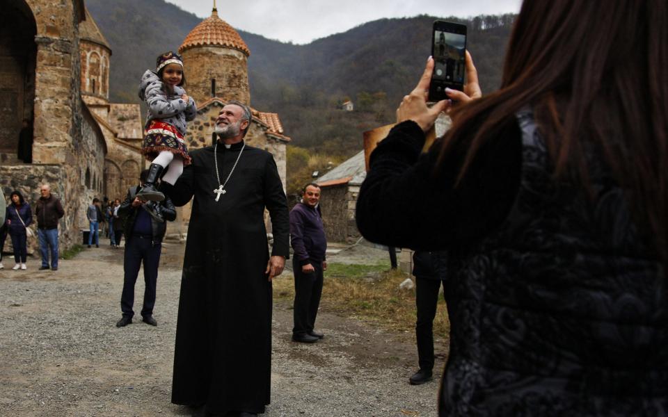 Father Hovhannes outside the Dadivank monastery in Kalbajar where he has carried out a final christening service - JACK LOSH FOR THE TELEGRAPH