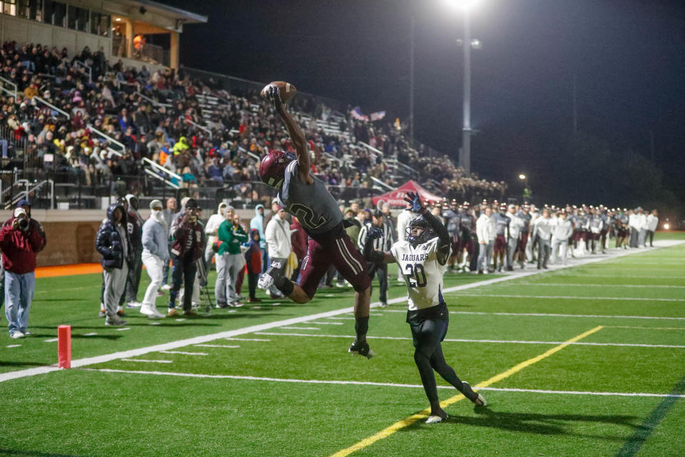 Benedictine's Thomas Blackshear attempts to haul in a Luke Kromenhoek pass over Spalding's Dylon Henderson during Friday night's state playoff game at Memorial Stadium.