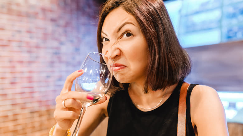 woman disgusted with bad wine