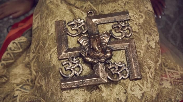 A Hindu swastika symbol is displayed at the home of Sheetal and Sanmeet Deo in Syosset, New York. Hindus, Buddhists and Native Americans are trying to rehabilitate the swastika, a symbol of peace and prosperity, and to restore it to a place of sanctity in their faiths. (Photo: Andres Kudacki/AP)