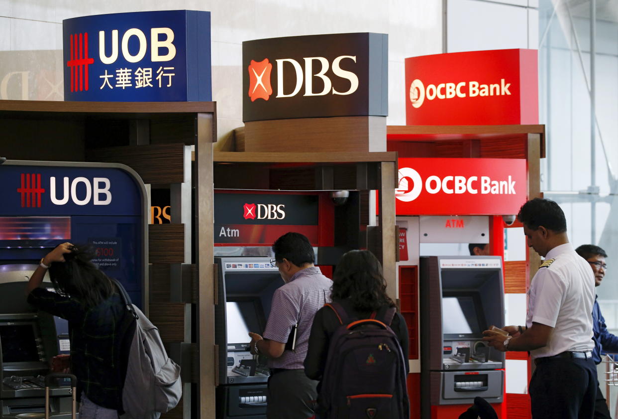 People use automated teller machines of United Overseas Bank Limited (UOB), DBS, and Oversea-Chinese Banking Corporation (OCBC) banks in Singapore.