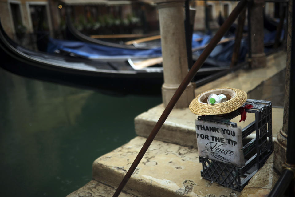 Gondolas are parked on a rainy day in Venice, Sunday, March 1, 2020. Italian tourism officials are worrying a new virus could do more damage to their industry than the Sept. 11 terror attacks. (AP Photo/Francisco Seco)