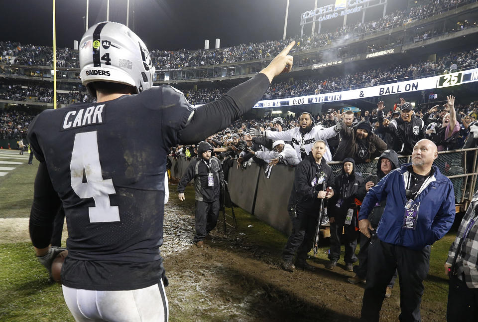 Oakland Raiders quarterback Derek Carr (4) gestures toward fans after an NFL football game against the Denver Broncos in Oakland, Calif., Monday, Dec. 24, 2018. (AP Photo/D. Ross Cameron)