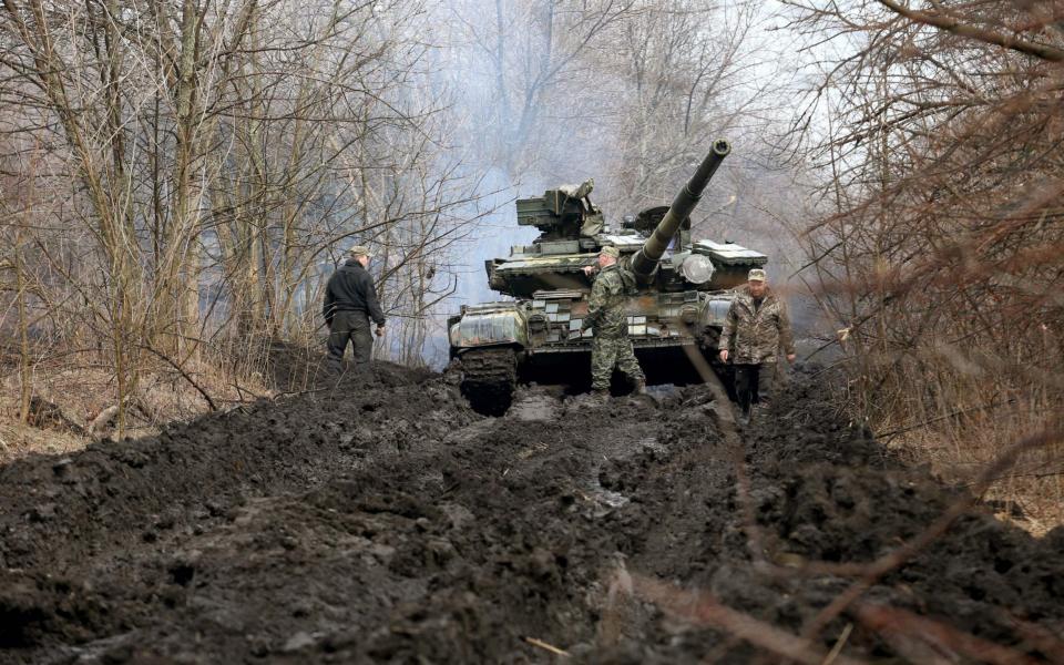 Ukrainian servicemen and a tank close to the front line with Russian-backed separatists near Lysychansk, Lugansk region  - AFP