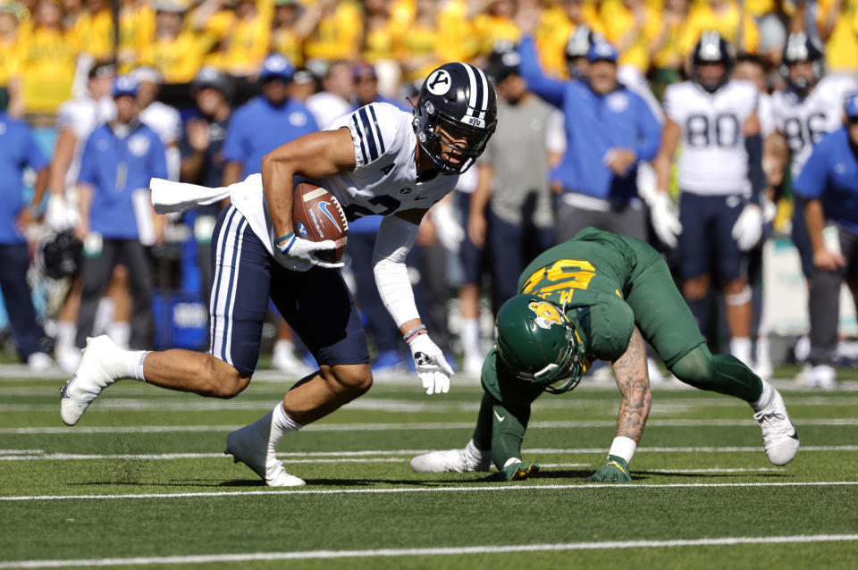 BYU wide receiver Neil Pau'u (2) takes a pass for a first down as he gets by Baylor linebacker Matt Jones (52) during the first half of an NCAA college football game Saturday, Oct. 16, 2021, in Waco, Texas. (AP Photo/Ron Jenkins)