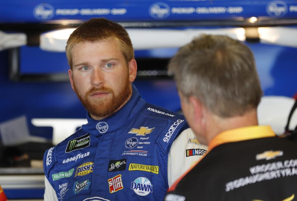 FILE - In this June 7, 2019, file photo, Chris Buescher talks to his crew after a practice session for a NASCAR Cup series race at Michigan International Speedway, in Brooklyn, Mich. Ricky Stenhouse Jr. and Roush Fenway Racing will split at the end of the season and Chris Buescher will replace him in 2020. Although his contract is believed to run through 2021, the team said Wednesday, Sept. 25, 2019, it will part ways with the two-time Xfinity Series champion at the end of the year. (AP Photo/Carlos Osorio, File)