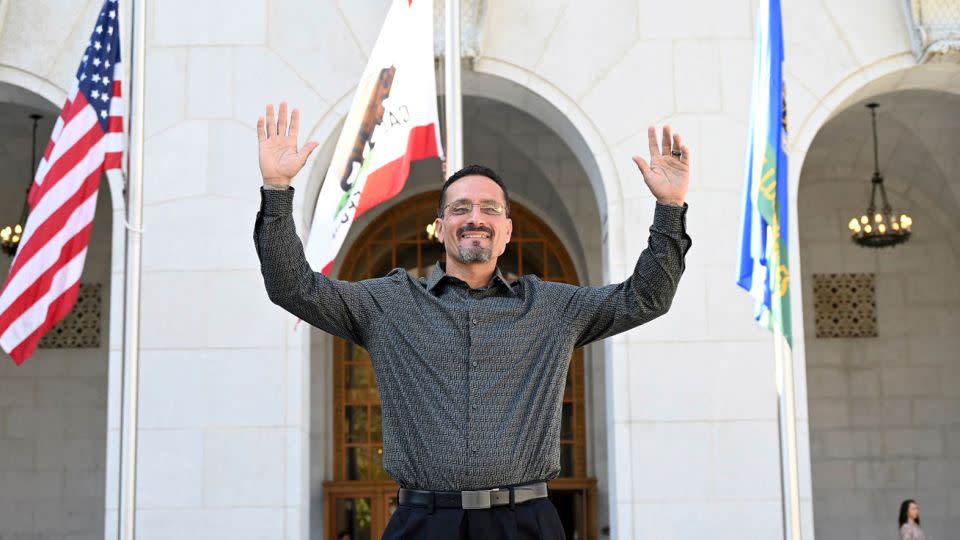 Gerardo Cabanillas waves from outside the Hall of Justice in downtown Los Angeles after his exoneration. - Laurence Colletti/Legal Talk Network/AP
