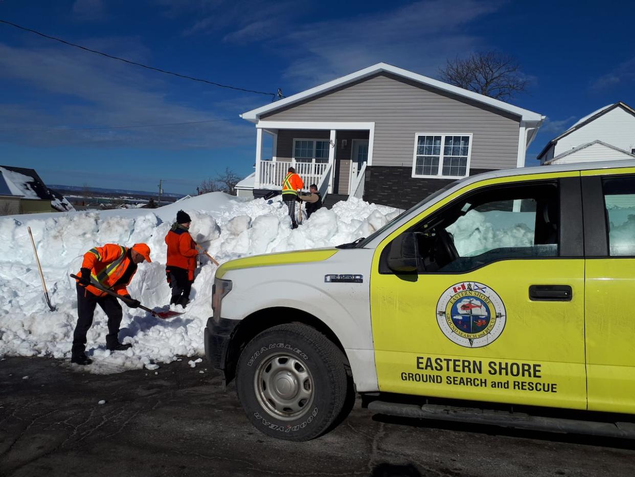 Search and rescue volunteers help shovel paths to homes of people in need of aid in the aftermath of February's heavy snowfall in Cape Breton.  (Eastern Shore Ground Search and Rescue  - image credit)