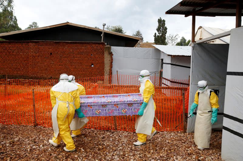 FILE PHOTO: Health workers dressed in Ebola protective suits carry a coffin with the body of Congolese woman Kahambu Tulirwaho, who died of Ebola, as it is transported for a burial from the Ebola treatment centre in Butembo