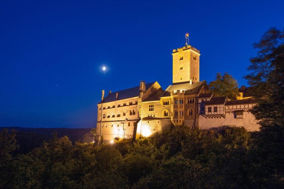 Wartburg Castle, shown here at night, gave Martin Luther the solitude he needed to be able to translate the New Testament into German in approximately 10 weeks. German National Tourist Board (courtesy)