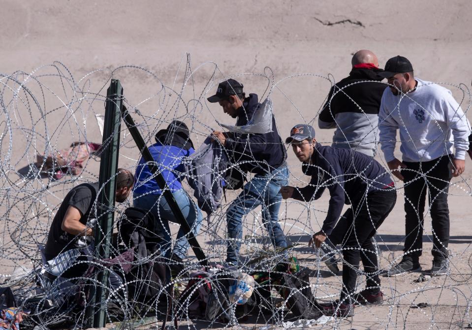 Migrants breached a section of concertina wire that had been placed on the north embankment of the Rio Grande by the Texas National Guard on the border between Ciudad Juárez and El Paso, Texas on Sept. 19, 2023.