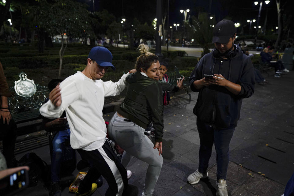 Youths dance during a rap performance at a plaza in the Coyoacan neighborhood of Mexico City, Friday, July 23, 2021. Hours after Mexico City authorities raised the alert level in the face of rising COVID-19 infections, many residents of the capital's trendy Coyoacan neighborhood crammed its center ignoring social distancing and forgoing masks. (AP Photo/Fernando Llano)