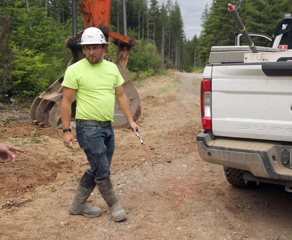 Tim Fredericks, an explosives engineer with McCallum Rock Drilling of Chehalis, holds the detonator in his hand as he prepares to ignite the explosives located down the road at Ueland Tree farm's newest Rock Quarry on Wednesday.